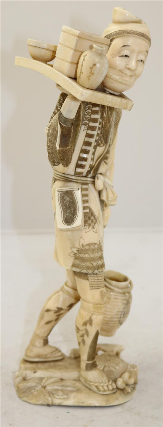 A large Japanese sectional walrus ivory figure of a man, early 20th century, 32cm